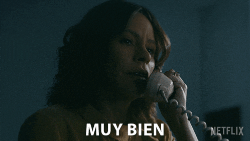 a woman talking on a telephone with muy bien written in the corner