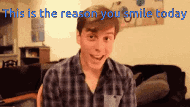 a man in a plaid shirt is smiling with the words " this is the reason you smile today " above him