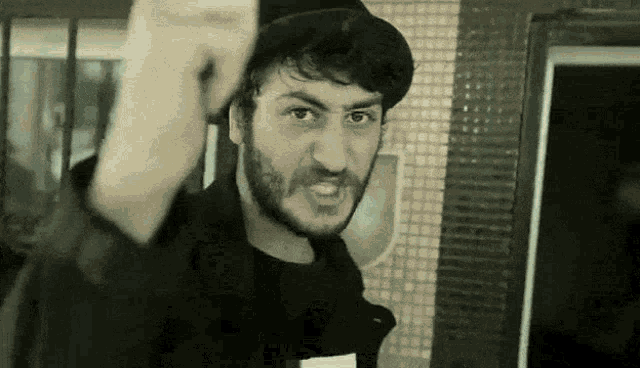 a man with a beard is wearing a top hat
