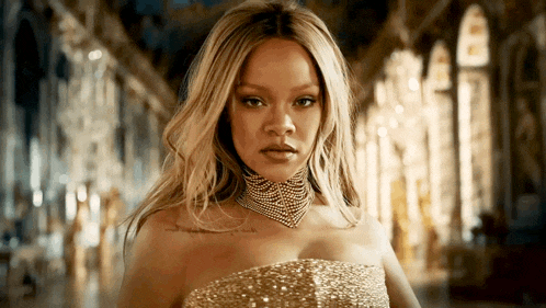 a woman in a gold dress has a tattoo on her shoulder that says " i love you "