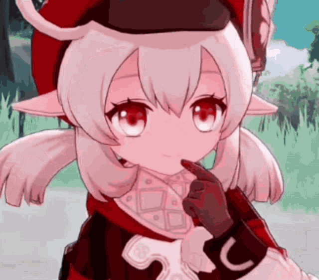 a girl with white hair and red eyes is wearing a red hat and holding her finger to her chin .