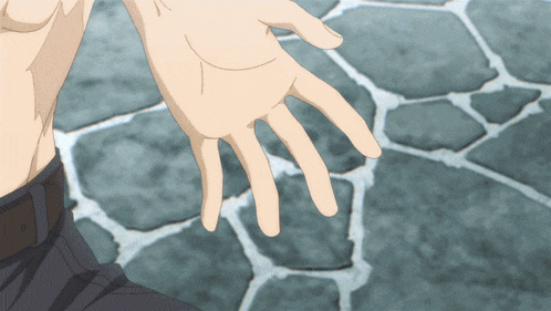 a close up of a person 's hand against a stone background