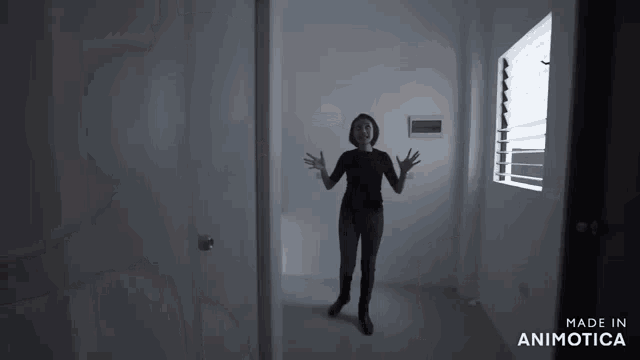 a woman is standing in a room with the words made in animotica on the bottom