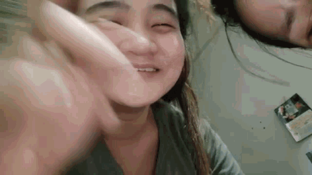 a man and a woman are taking a selfie with their heads together .