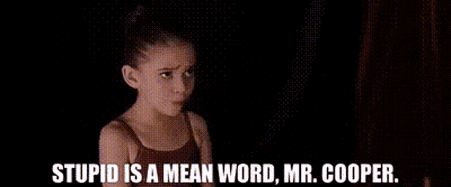 a man in a suit is smoking a cigarette and says stupid is a mean word mr. cooper .