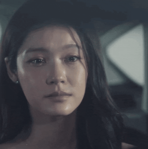 a woman with tears running down her face is wearing a watch