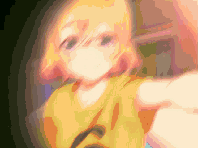 a blurry picture of a girl with a yellow shirt on