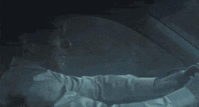 a man in a white shirt and tie is driving a car