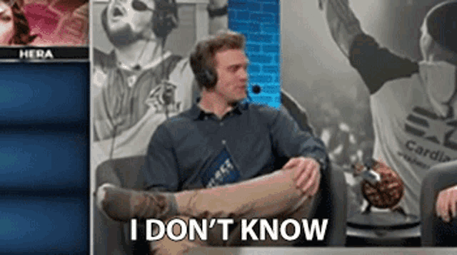 a man wearing headphones is sitting on a couch with his legs crossed and the words i don 't know behind him