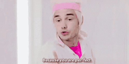 a man is wearing a pink headband and saying `` because you are perfect '' .
