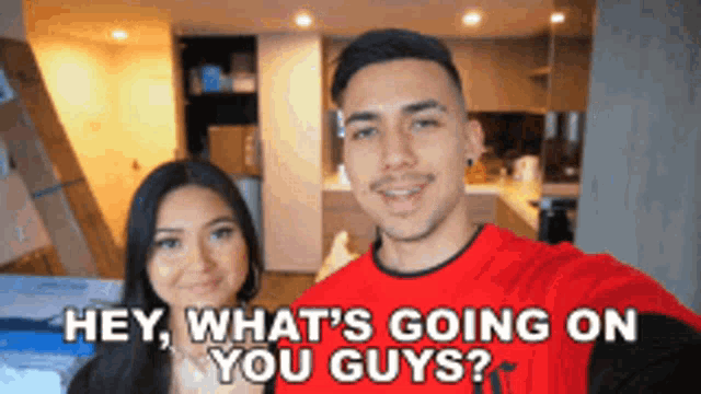 a man and a woman are taking a selfie and the man is asking the woman what 's going on