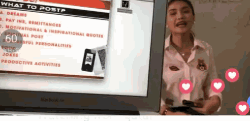 a woman stands in front of a screen that says what to post on it