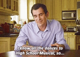 a man is sitting at a table in a kitchen and says " i know all the dances to high school musical "