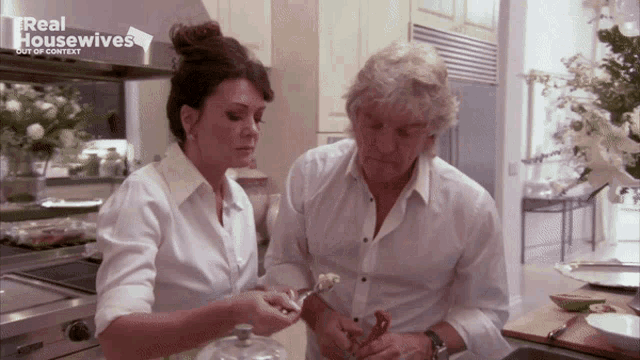 a man and a woman in a kitchen with the words real housewives out of context on the bottom