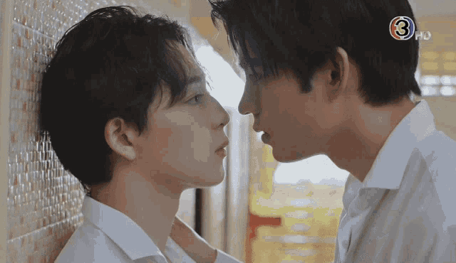 two men are kissing and the number 3 is on the right