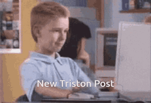 a boy sitting in front of a computer with the words new triston post