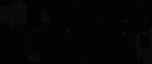 a group of women are dancing together in a room with candles .