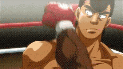 a man in a boxing ring wearing red boxing gloves is holding a punch .