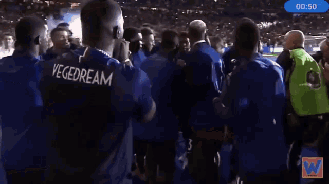 a group of soccer players huddle together with the time of 00:51 on the bottom