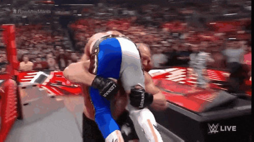a wrestling match is being shown on a screen that says w live