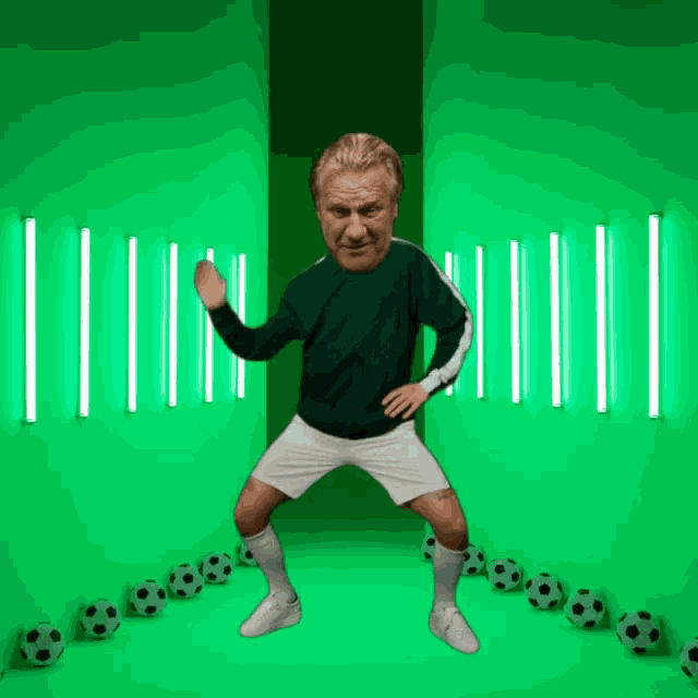 a man in a green shirt and white shorts is dancing in front of a green background