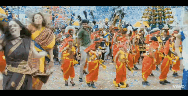 a group of people are dancing in a colorful parade .