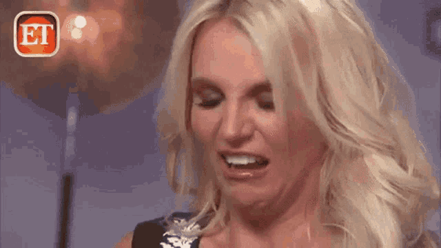 a close up of a woman making a funny face with her mouth open .
