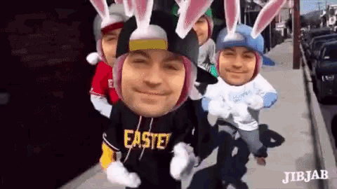 a group of people are wearing bunny ears and a shirt that says easter