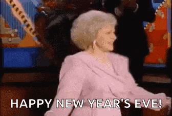 a woman in a pink dress is dancing and saying `` happy new year 's eve '' .