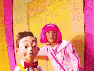 a girl with pink hair is standing next to a boy