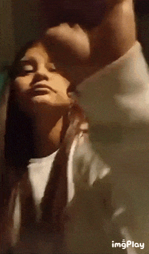 a close up of a man kissing a woman on the neck .
