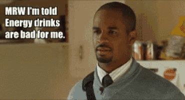 a man in a suit and tie is saying that energy drinks are bad for him
