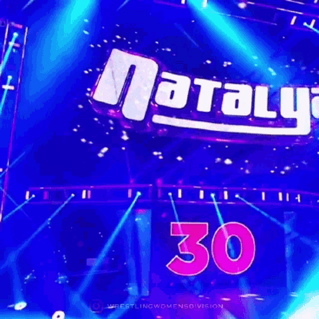 a woman stands in front of a large pink number 3