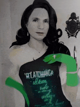 a woman wearing a black shirt that says " rat.atchianca " on it