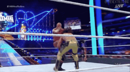 two wrestlers are wrestling in a ring with a sign that says wwe live
