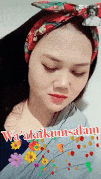a woman wearing a headband with flowers and the words ya ' alaikumsalam