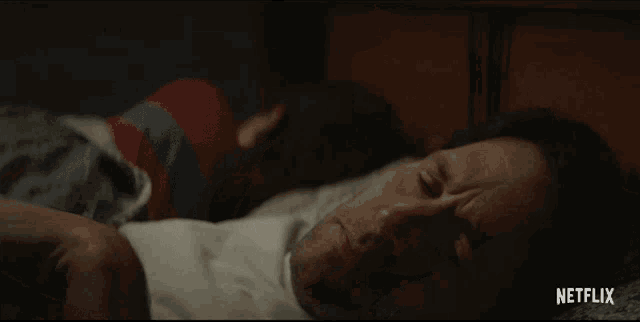 a man laying on a bed with netflix written on the bottom