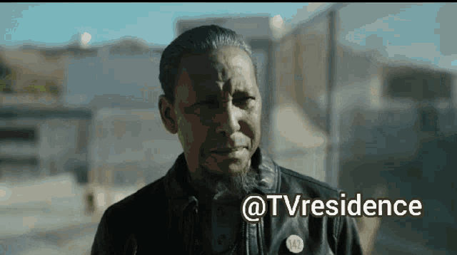 a man in a leather jacket is crying with the words @tvresidence above him .