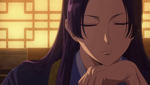 a woman with long purple hair is sitting with her eyes closed