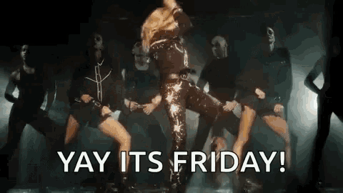 a woman is dancing on a stage with a group of dancers and the words `` yay its friday '' .