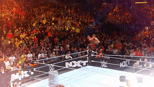 a wrestler in a ring with a sign that says nxt