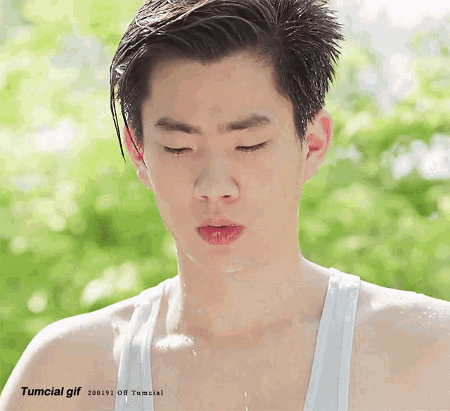 a close up of a man 's face with the words tumcial gif written below it