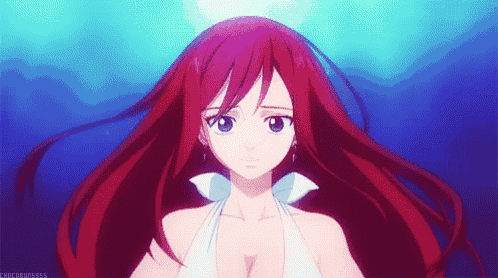 a girl with long red hair is wearing a white dress and earrings .