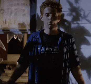 a man wearing a black shirt that says alloy
