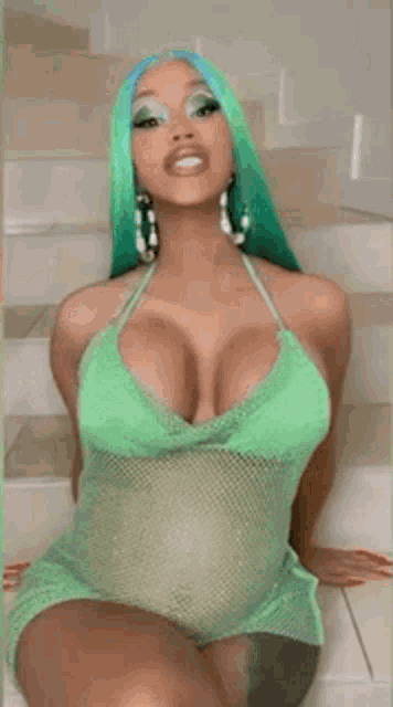a pregnant woman with green hair is sitting on a set of stairs .