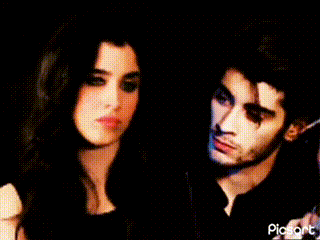 a man and a woman are looking at each other .