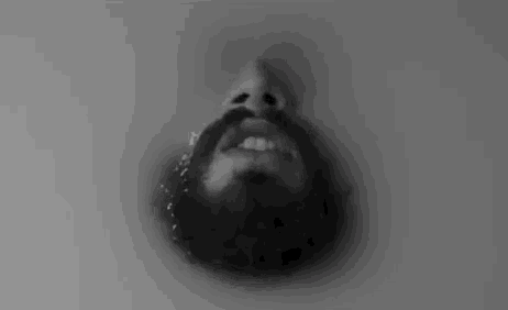 a black and white photo of a man with a beard and mustache .