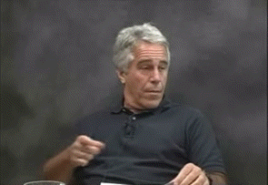 a man in a black shirt is waving his hand in the air
