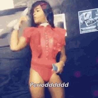 a woman in a red leotard is holding a microphone and says perioddddd .