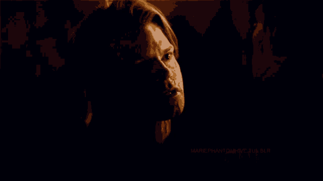 a man and a woman are kissing in a dark room with mariephantom wear a blur written on the bottom